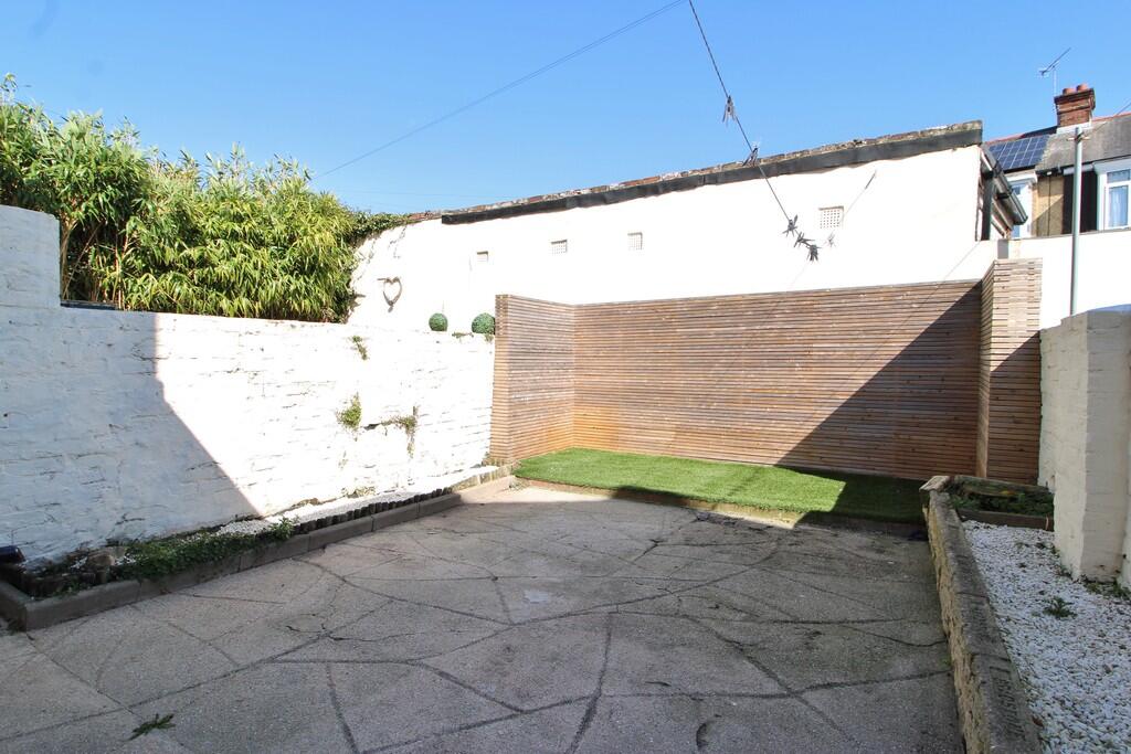 Heidelberg Road rear yard before refurbishment — cracked concrete and bare walls